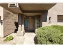 Inviting front entrance with stone pathway, lush greenery, and decorative glass block window at 7240 N Dreamy Draw Dr # 109, Phoenix, AZ 85020