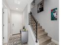 Hallway with carpeted stairs, metal banister, modern decor, and grey storage cabinet at 820 N 8Th Ave # 25, Phoenix, AZ 85007