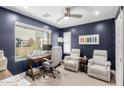 Comfortable home office with a large window, desk, swivel chair, and seating area with recliner chairs at 820 N 8Th Ave # 25, Phoenix, AZ 85007