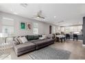 Open concept living room with large sectional couch, tile flooring, and dining area with bright natural light at 820 N 8Th Ave # 25, Phoenix, AZ 85007