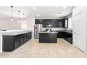 Spacious kitchen with stainless steel appliances, ample dark cabinetry, and a granite-topped center island at 8872 W Hollywood Ave, Peoria, AZ 85345