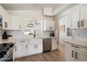 Bright kitchen featuring white cabinets, stainless steel appliances, farmhouse sink, and ample counter space at 9143 W Kings Ave, Peoria, AZ 85382
