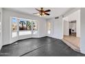 Bright, tiled living room with large windows offering views of a desert landscape at 1023 E Sahuaro Dr, Phoenix, AZ 85020
