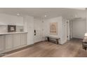 Inviting entryway features beautiful hardwood floors, stylish built-in cabinetry, and modern decor at 106 E Echo Ln, Phoenix, AZ 85020