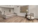 Bright living room with hardwood flooring, neutral-toned furniture, and modern artwork at 106 E Echo Ln, Phoenix, AZ 85020