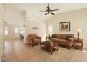 Comfortable living room featuring a ceiling fan, neutral colors and a cozy seating arrangement at 1202 W Wickieup Ln, Phoenix, AZ 85027