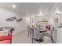 Charming dining area with striped chairs, a round table, and stylish wall decor at 12212 N Paradise Vlg S Pkwy # 113, Phoenix, AZ 85032