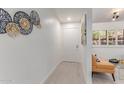 Bright hallway with clean lines, contemporary wall decor, and wood-look flooring at 12212 N Paradise Vlg S Pkwy # 113, Phoenix, AZ 85032