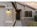 Close up of the home's entrance with a modern front door and attractive desert landscaping at 13723 W Rovey Ave, Litchfield Park, AZ 85340