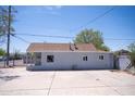 Rear exterior view of a one-story home showing a large concrete parking area at 1410 S 24Th Ave, Phoenix, AZ 85009