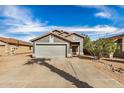 Single-story home with a two-car garage, desert landscaping, and tile roof, offering curb appeal at 15339 N 148Th Ct, Surprise, AZ 85379