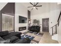 Cozy living room features a vaulted ceiling, fireplace, and modern decor at 15339 N 148Th Ct, Surprise, AZ 85379