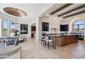 Bright gourmet kitchen featuring a large island, stone accents, and modern stainless steel appliances at 15427 E Firerock Country Club Dr, Fountain Hills, AZ 85268