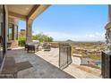 Outdoor patio with comfortable seating, a built-in grill, and stunning mountain views at 15427 E Firerock Country Club Dr, Fountain Hills, AZ 85268