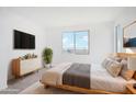 Bright bedroom with large windows, minimalist décor, and a calming atmosphere, perfect for relaxation at 15627 W Hackamore Dr, Surprise, AZ 85387