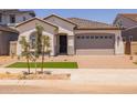 Charming single-story home featuring a manicured front yard and a two-car garage at 15642 W Georgia Dr, Surprise, AZ 85379