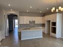 Bright open kitchen boasts an island, ample cabinet space, and modern appliances at 15642 W Georgia Dr, Surprise, AZ 85379