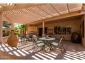 Relaxing outdoor patio covered by a pergola with stylish patio furniture for seating and shade at 16240 W Talara Way, Surprise, AZ 85374