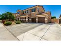 Spacious two-story home featuring a three-car garage and long driveway at 16245 W Papago St, Goodyear, AZ 85338