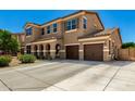 Spacious two-story home featuring a three-car garage and long driveway at 16245 W Papago St, Goodyear, AZ 85338