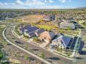 An aerial view shows homes in a large neighborhood with desert landscaping at 18381 W La Senda Dr, Surprise, AZ 85387