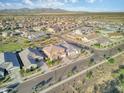 Aerial view of a neighborhood of homes with desert landscaping on a partly cloudy day with mountains in the distance at 18381 W La Senda Dr, Surprise, AZ 85387