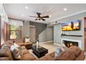 Cozy living room features a fireplace, ceiling fan, and comfortable seating at 19777 N 76Th St # 1106, Scottsdale, AZ 85255