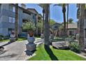 Beautifully landscaped walkway with lovely planters leading to common areas of the complex at 2025 E Campbell Ave # 248, Phoenix, AZ 85016
