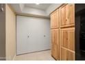 Kitchen with cabinets and convenient access to laundry area behind doors at 2407 W Rue De Lamour Ave, Phoenix, AZ 85029