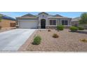 Inviting single-story home featuring an attached two-car garage, low maintenance landscaping, and a covered front entryway at 30446 W Picadilly Rd, Buckeye, AZ 85396