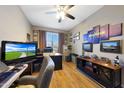 A home office featuring a built-in storage cabinet and decor, a large monitor, and neutral paint at 30446 W Picadilly Rd, Buckeye, AZ 85396