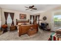 Comfortable main bedroom with a ceiling fan, natural light, and a dedicated desk area at 3578 E Walnut Rd, Gilbert, AZ 85298