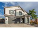 Beautiful two-story home showcasing neutral tones, desert landscaping, and a spacious two-car garage at 38659 N Alamo Ct, San Tan Valley, AZ 85140