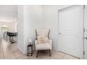 Cozy entryway with a decorative chair and view of the kitchen area at 39959 W Williams Way, Maricopa, AZ 85138