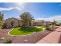 A single-story home with a three-car garage, desert landscaping, and a mature tree in the front yard at 4055 N Recker Rd # 62, Mesa, AZ 85215