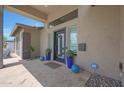 Covered front porch featuring unique planters, decorative orbs, and a modern front door at 4714 E Lewis Ave, Phoenix, AZ 85008