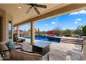 Enjoy the covered patio and views of this custom pool and backyard area with a firepit and BBQ at 5621 E Lonesome Trl, Cave Creek, AZ 85331