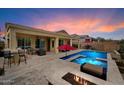 Entertain in this outdoor oasis with a pool, spa, covered patio, built-in BBQ, and cozy fire pit area at 5621 E Lonesome Trl, Cave Creek, AZ 85331