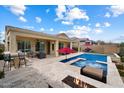 Entertain in this outdoor oasis with a pool, spa, covered patio, built-in BBQ, and cozy fire pit area at 5621 E Lonesome Trl, Cave Creek, AZ 85331
