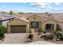 Charming single-story home featuring a tile roof, two-car garage, desert landscaping, and a welcoming front porch at 5621 E Lonesome Trl, Cave Creek, AZ 85331
