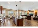 Bright, open kitchen with stainless appliances, island seating, and adjoining living spaces at 5621 E Lonesome Trl, Cave Creek, AZ 85331