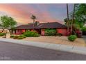 Inviting single-story home with lush greenery, a desert-friendly landscape, and a well-maintained facade at 6101 E Thunderbird Rd, Scottsdale, AZ 85254