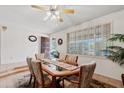 Cozy dining area featuring an inviting dining table set, with tile flooring and natural light streaming through the shutters at 6237 E Boston St, Mesa, AZ 85205