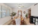 Formal dining room featuring elegant table with seating for eight, tile flooring, and natural light from the window at 6237 E Boston St, Mesa, AZ 85205
