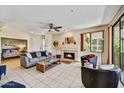 Spacious living room with fireplace, tiled floors, access to the bedroom, and bright natural light at 7700 E Gainey Ranch Rd # 124, Scottsdale, AZ 85258