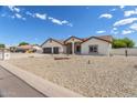 Well-maintained single-story home featuring desert landscaping and a three-car garage at 8207 W Planada Ln, Peoria, AZ 85383