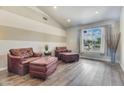 Comfortable living room with vaulted ceiling, wood-look floors and comfortable seating at 8207 W Planada Ln, Peoria, AZ 85383