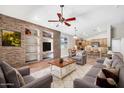 Spacious living room featuring a stone accent wall, built-in shelves, and open floor plan at 8465 W Andrea Dr, Peoria, AZ 85383
