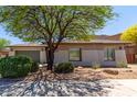 Exterior side view showcasing a beige home with desert landscaping at 8647 W Lariat Ln, Peoria, AZ 85383
