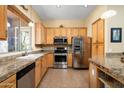 Well-lit kitchen with granite countertops and stainless steel appliances at 9543 E Kiisa Dr, Scottsdale, AZ 85262
